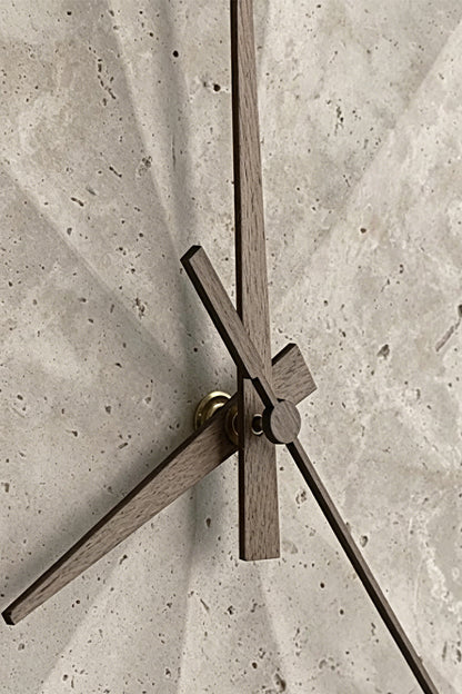 Petra Compass Travertine Backlit Wall Lamp | Travertine, Iron | Extreme macro close-up of the dark iron compass-like hands fixed onto the textured travertine surface | Detail shot | vexa lamps
