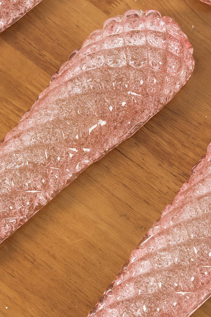 Amara Blush Cascading Glass Chandelier | Glass, Metal | Close-up focus on two detached textured blush pink glass panels displaying their rich ribbed patterns | Detail shot | vexa lamps