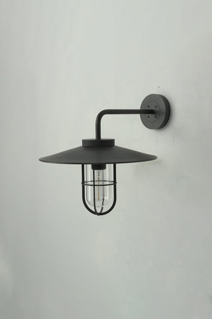 Side profile of black Portree wall light | Metal, Glass | Mounted on a wall showing the gooseneck shape | vexa lamps