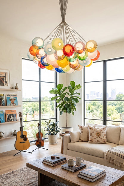 Rainbow Glass Bubble Cluster Chandelier | Glass, Metal | Illuminating a bright, contemporary lounge room featuring a cream sectional sofa and large windows with greenery views | vexa lamps