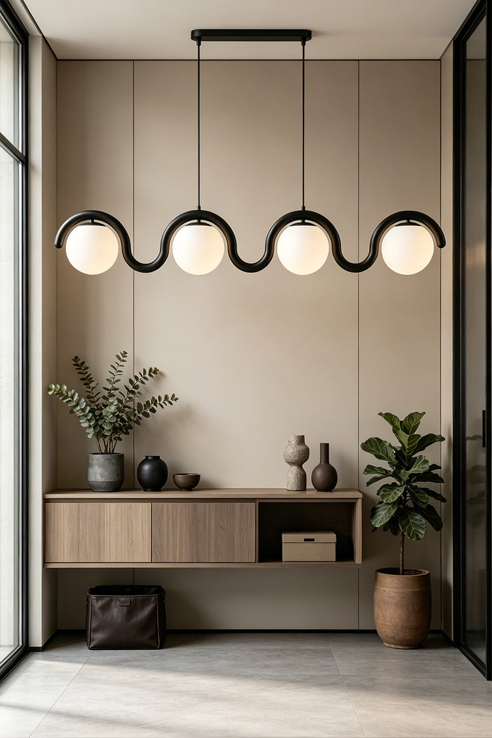 Rhythmic flow glass pendant with wavy black metal frame | Metal, Glass | Installed over a console table in a bright hallway | vexa lamps