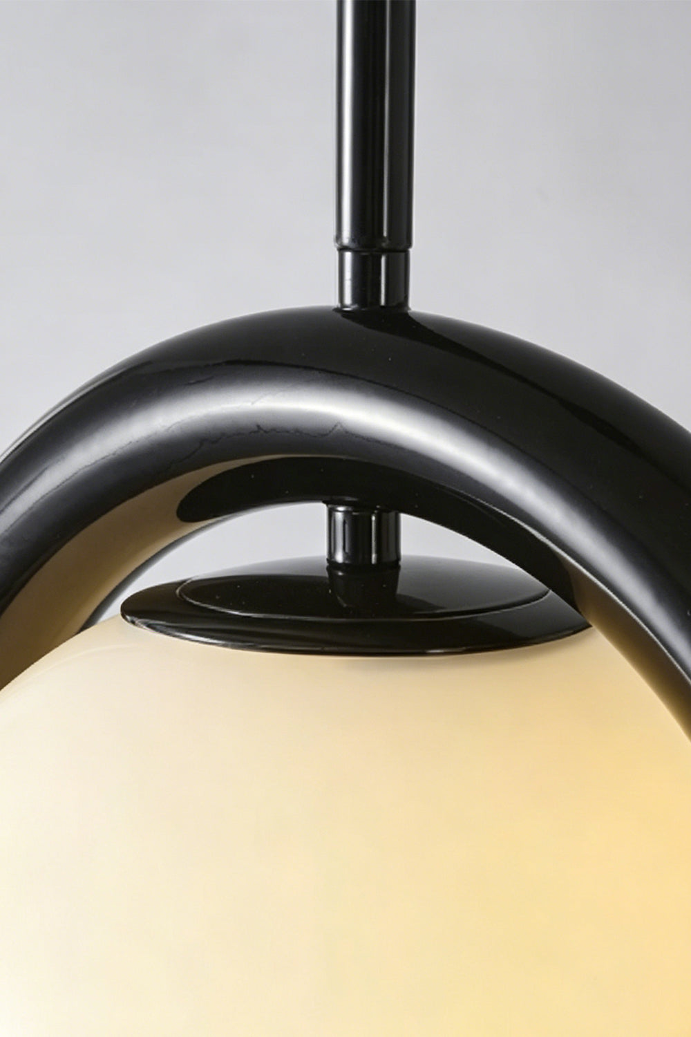 Close-up of the rhythmic flow pendant in black finish | Metal, Glass | Detailed shot of the metal bracket and cord connection | vexa lamps