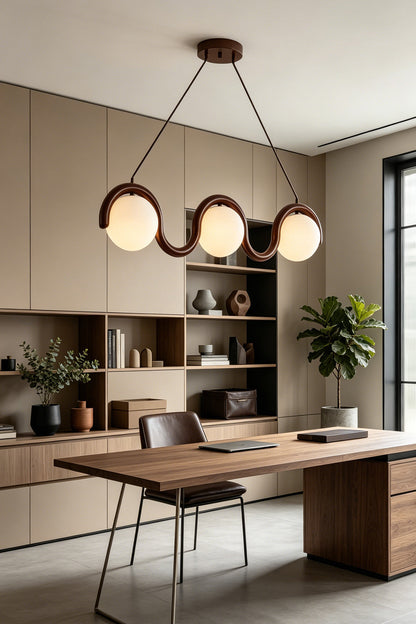 3-light linear glass pendant over a wooden office desk | Metal, Glass | Home office setting with minimalist decor | vexa lamps