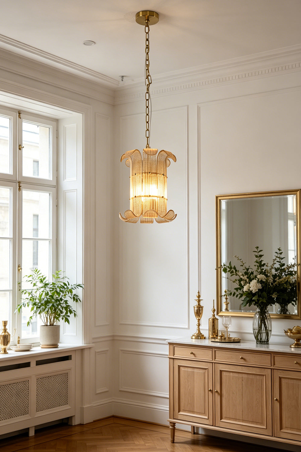 Elegant ribbed glass scroll chandelier | Metal | Glass | Installed in a bright traditional living room over a wooden cabinet | vexa lamps