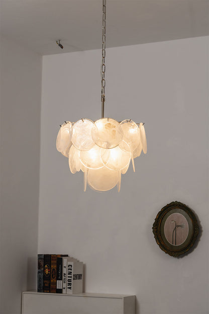 Romilly Layered Glass Disc Chandelier illuminating a stylish interior with its unique design and warm light.