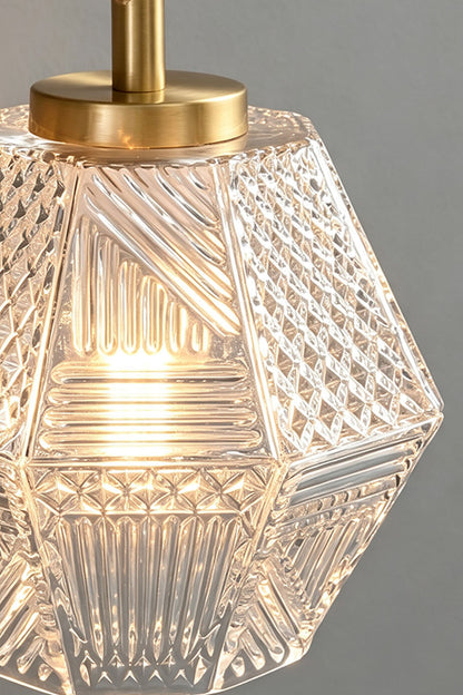 Rosamund Faceted Glass Wall Sconce | Faceted Glass and Brass | Close-up detail of the illuminated clear faceted glass shade | vexa lamps