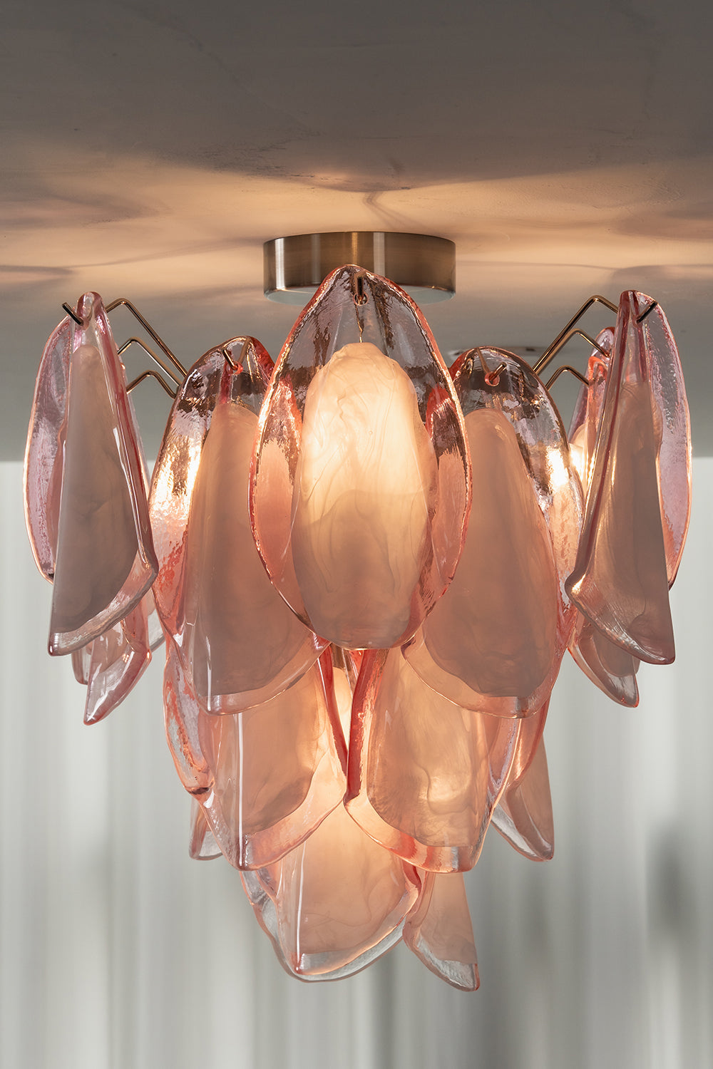 Close-up of lit Seraph petal glass light on a ceiling | Glass, Metal | Showing the warm glow and petal texture | vexa lamps