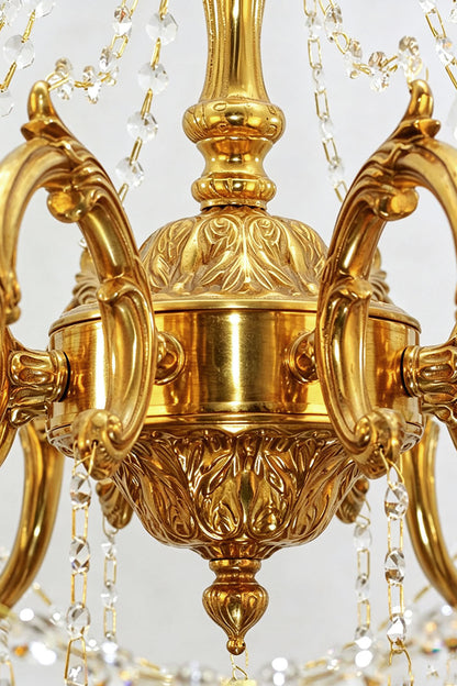 Close-up view of the intricate detailing on the Sidonie Scrolled Brass Crystal Chandelier, showcasing its elegant brass finish.