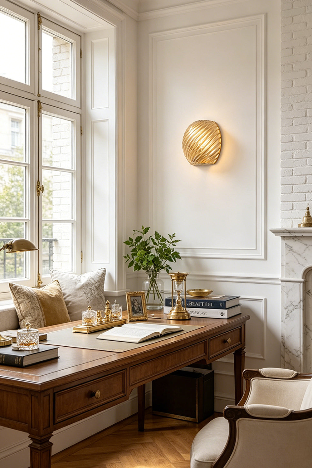 Silas Ribbed Glass Wall Sconce | Ribbed Glass, Metal | Mounted as an elegant amber gold accent light on a white wall above a classic wooden executive desk in a home office | vexa lamps