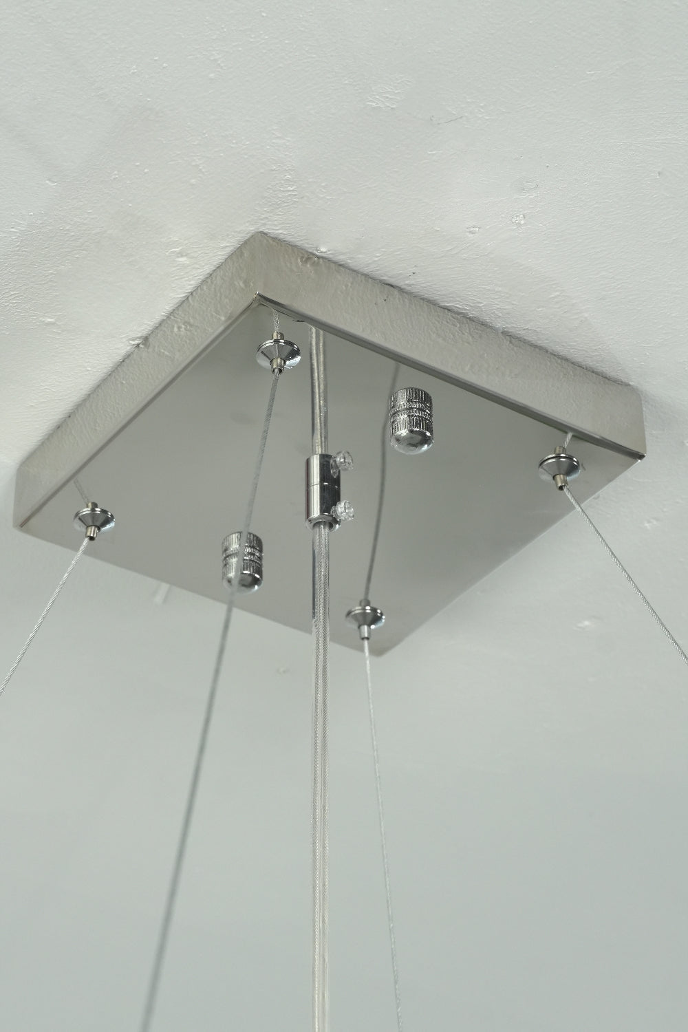 Square stainless steel ceiling canopy and hanging wires | Stainless Steel | Close-up of the mounting hardware for the chandelier | vexa lamps