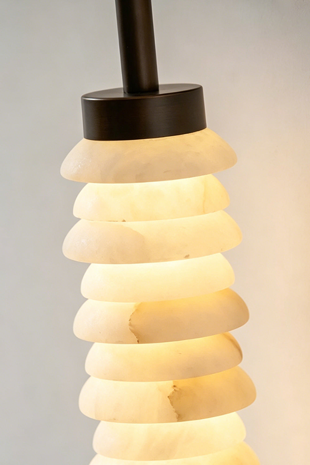 Stacked Strata Alabaster Wall Lamp | Metal, Alabaster | Lit lamp near dark modern kitchen cabinets | vexa lamps