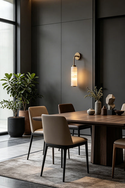 Stacked Strata Alabaster Wall Lamp | Metal, Alabaster | Lit lamp casting warm light in modern dining interior | vexa lamps