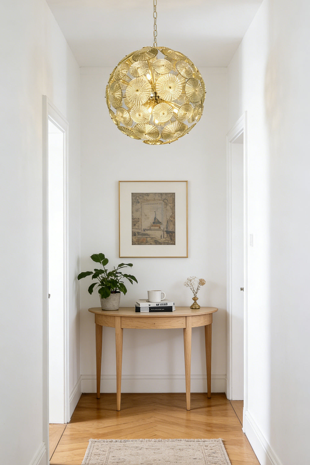 Lit modern classic spheres chandelier | Metal, Glass | Installed at the end of a corridor over a console table | morylighting