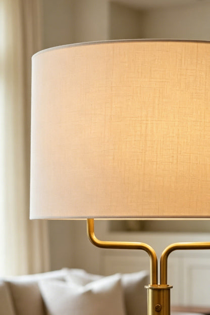Close-up of the Sutton Modern Brass Floor Lamp shade, showcasing its classic white linen texture and design elegance.