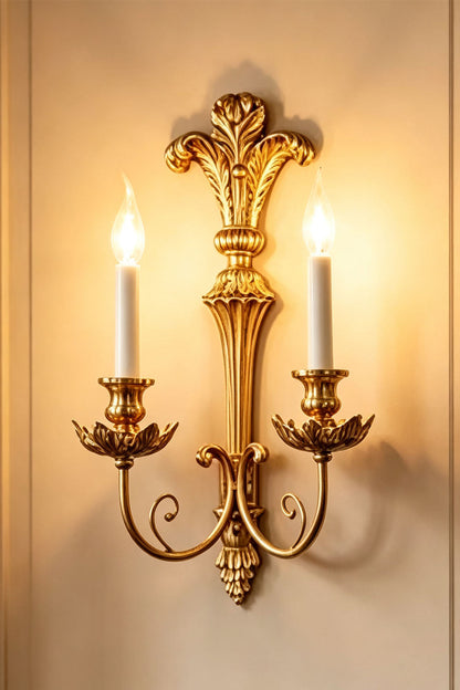 Tamsin Carved Plume Candle Wall Lamp | Carved Resin and Brass | Full view of the double candle sconce glowing warmly on a plain wall | vexa lamps