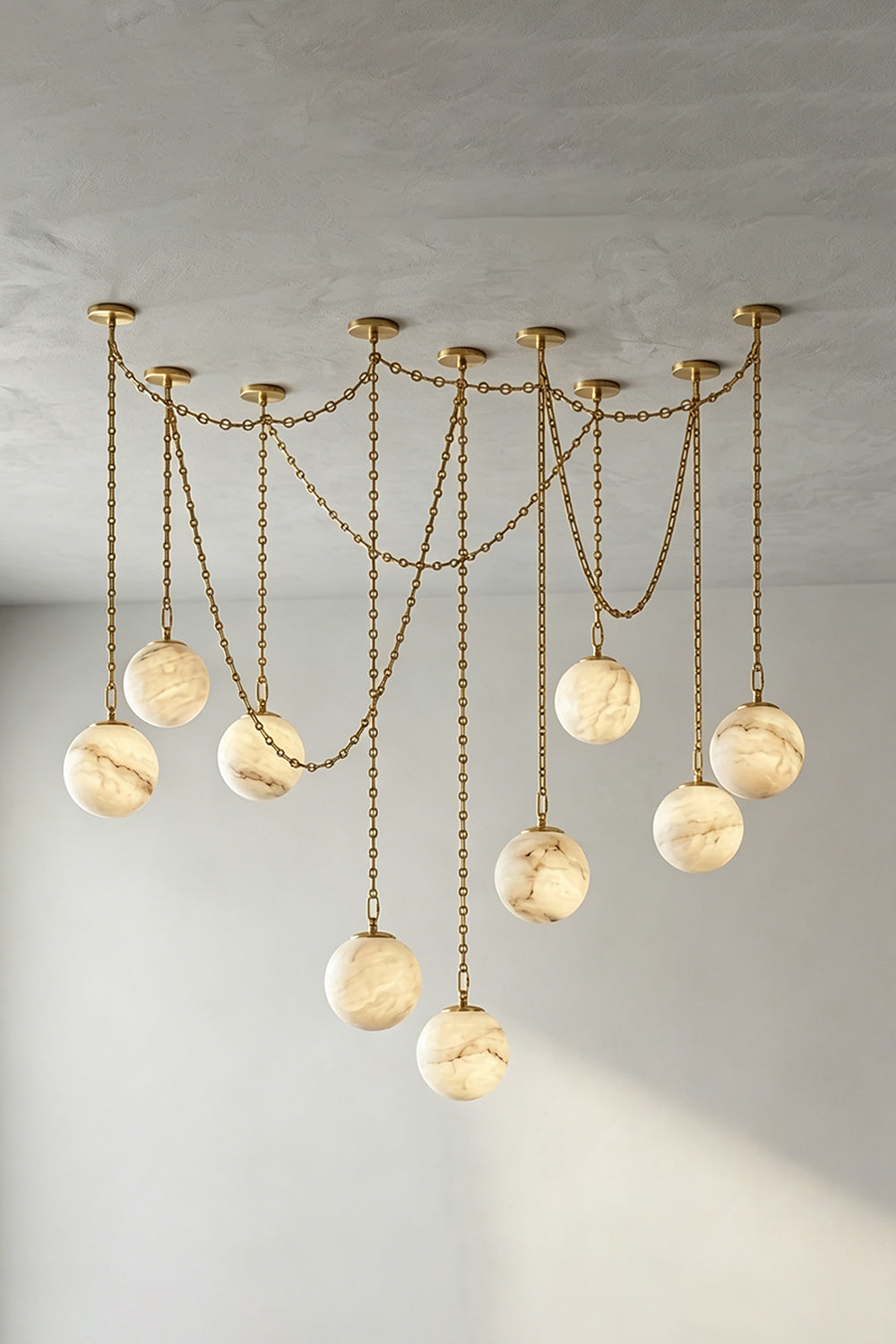 Thalia Alabaster Spherical Chain Chandelier with hand-carved alabaster spheres and brushed links.