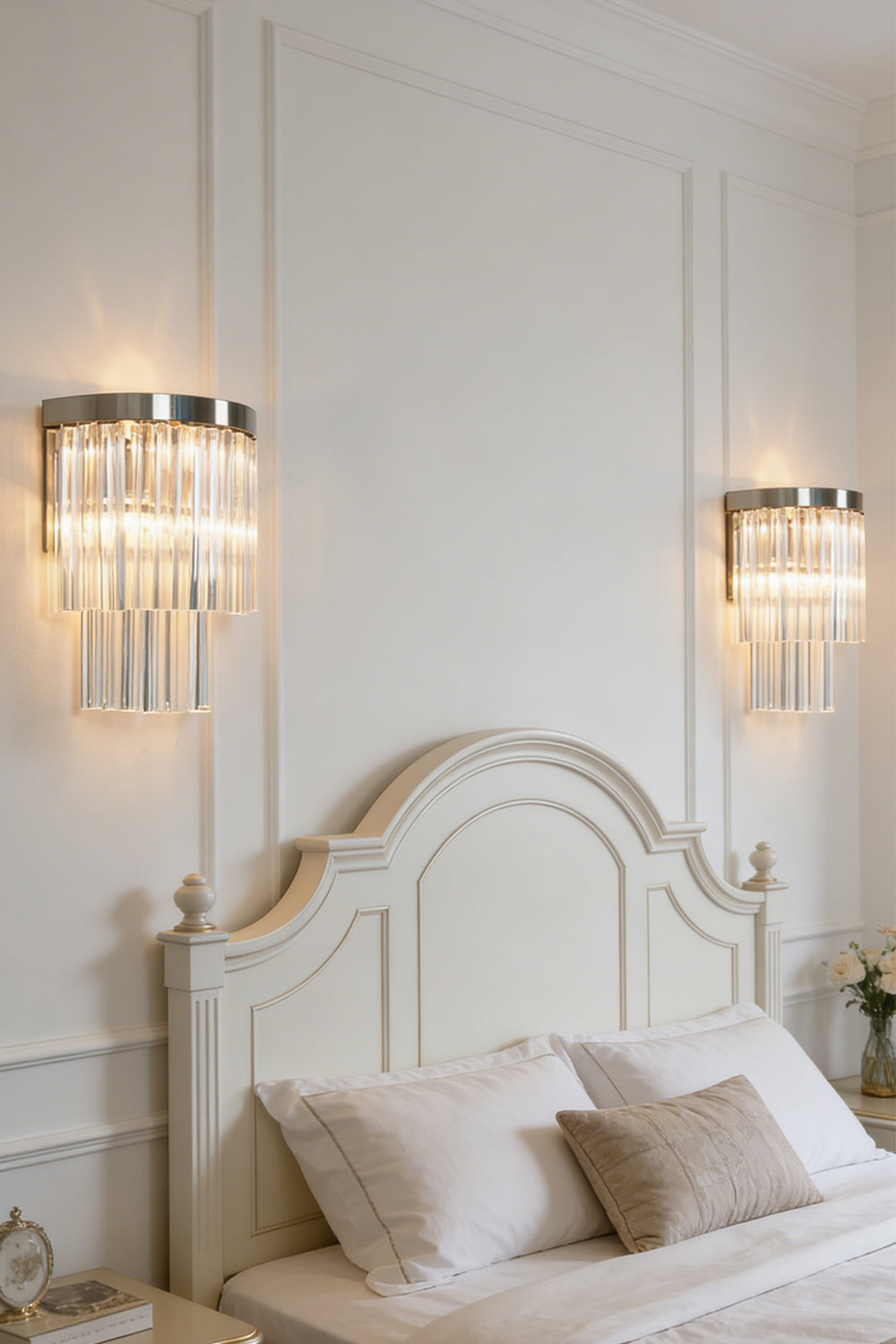 Lit tiered column glass wall light | Metal, Glass | Installed on a classic white wall over a bedside nightstand | morylighting