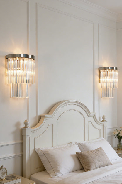Lit tiered column glass wall light | Metal, Glass | Installed on a classic white wall over a bedside nightstand | morylighting
