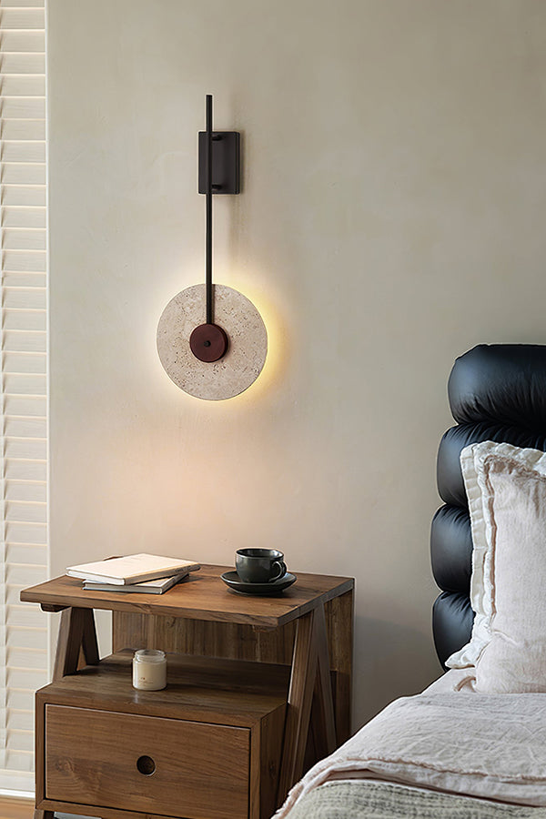 Modern travertine sconce in a luxury bedroom | Travertine, Wood, Metal | Next to a black leather headboard | vexa lamps