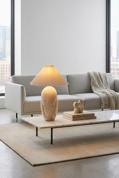 Statement stone table lamp | Travertine, Fabric | Centered on a large coffee table in a modern lounge | vexa lamps