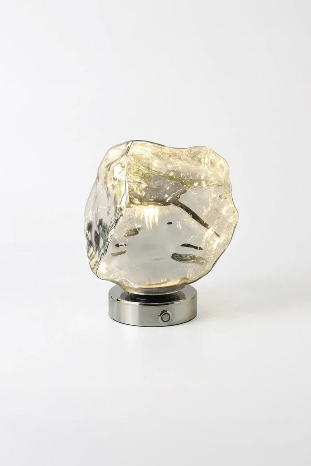 Vega Molten Metal Table Lamp with a sculptural, irregular base and reflective surface, ideal for any modern decor.