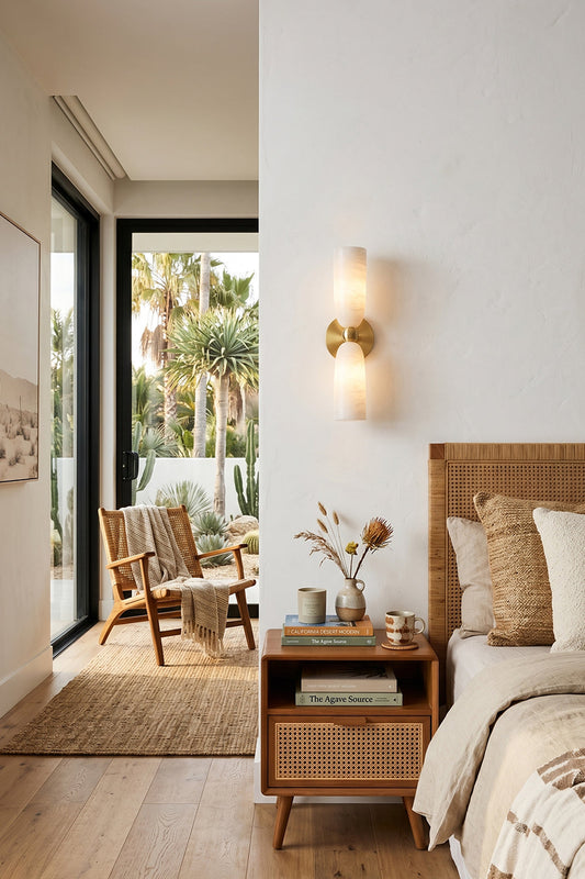 Vesperal Axis Alabaster Wall Lamp | Alabaster, Metal | Mounted as bedside lighting in a neutral-toned bedroom with rattan furniture | vexa lamps
